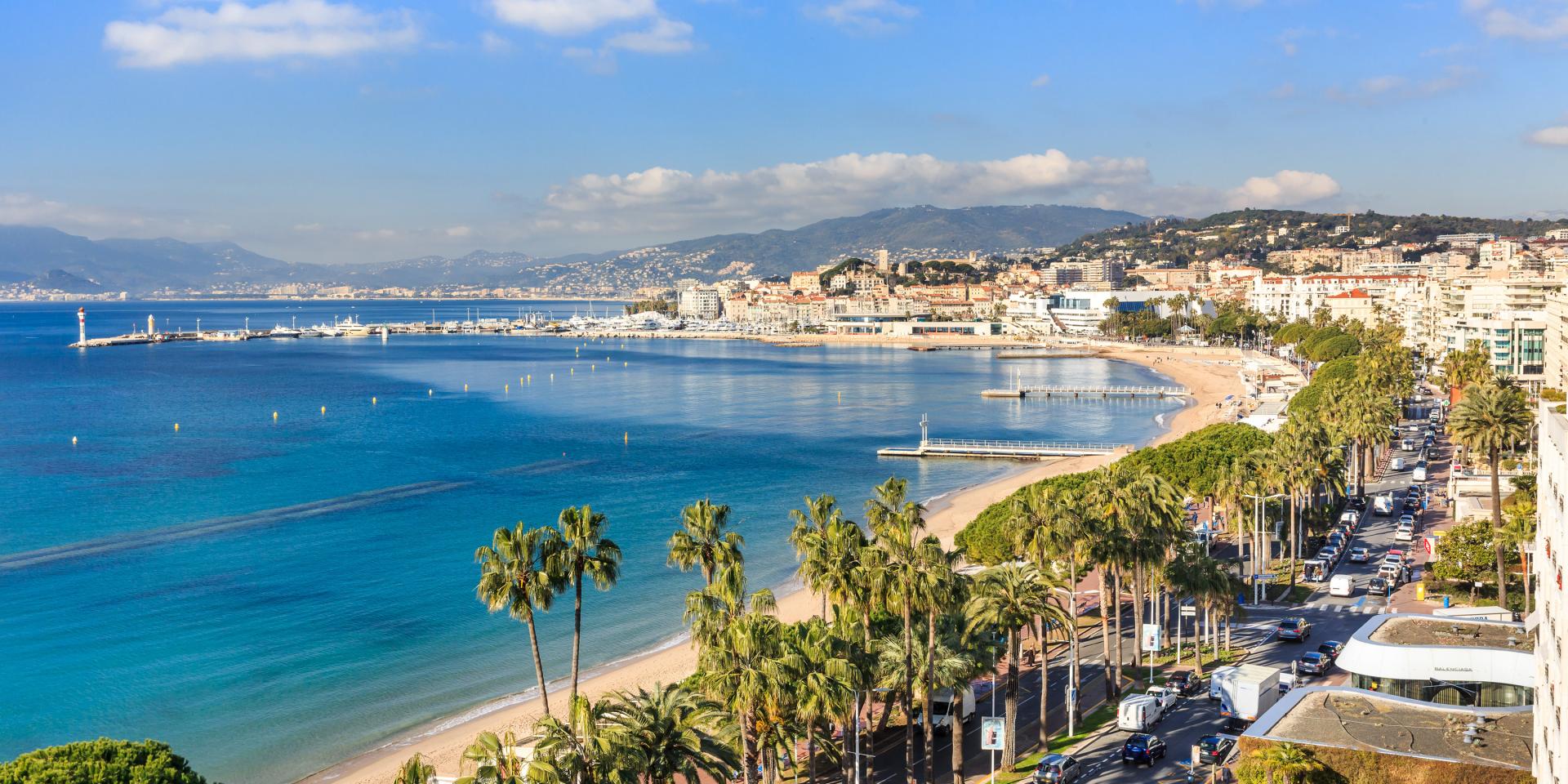 La Croisette seafront in Cannes with luxury yachts anchored offshore