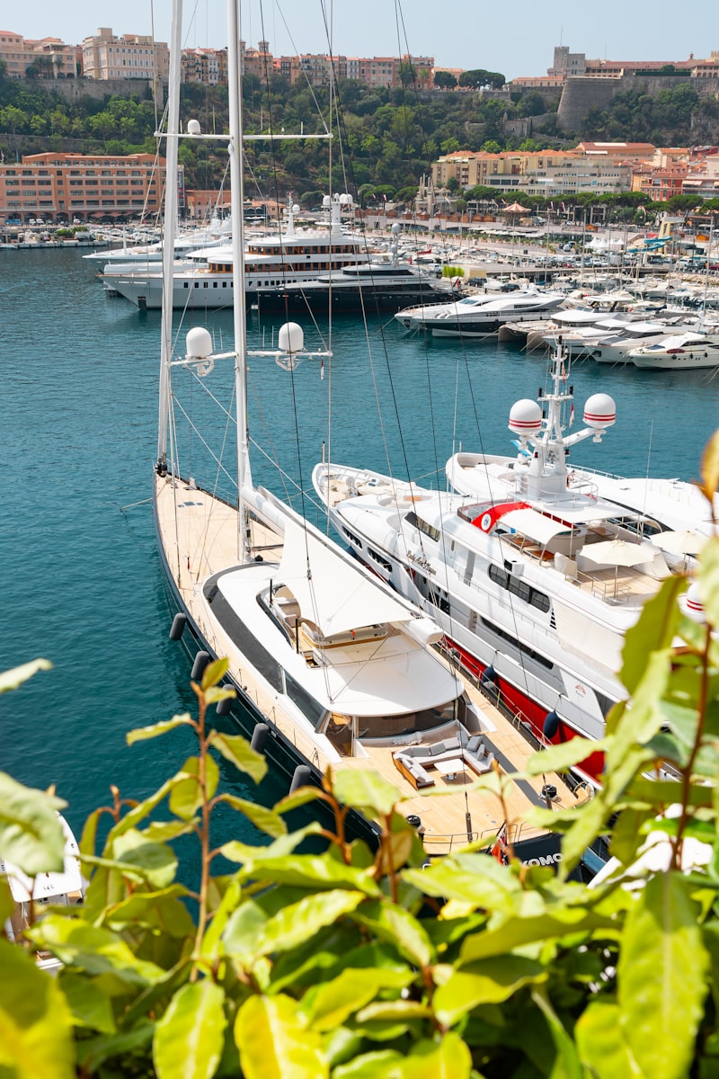 Superyacht anchored in Monaco harbour with Monte Carlo skyline