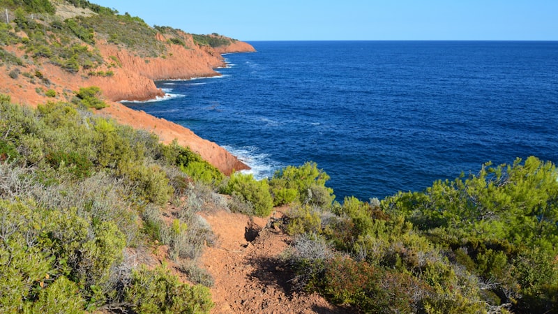 Stunning red-rock coastline of the Esterel seen from a yacht on the French Riviera
