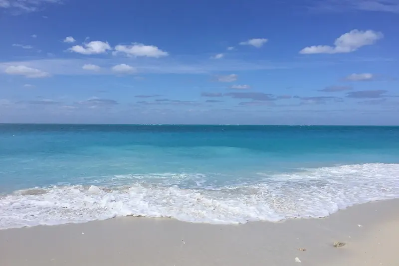 Turquoise surf on a white sand beach in Providenciales, Turks and Caicos